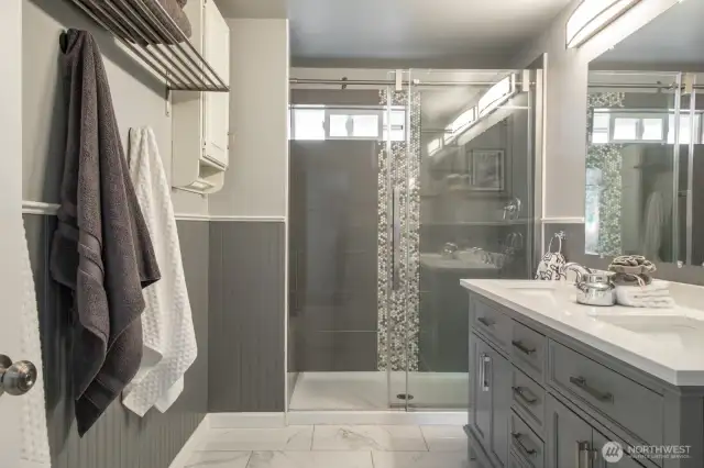 A luxury, spa-inspired bathroom sits just off the primary bedroom—offering seamless access, everyday function, and a serene space to unwind.