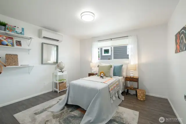 The spacious second bedroom comes complete with floating shelves, adding both function and a stylish display option.