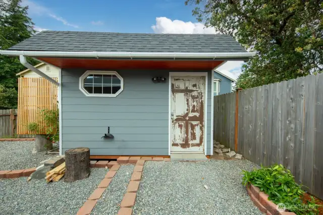 A high-quality shed sits conveniently beside the garden—perfect for storing tools, gear, and all your outdoor essentials.