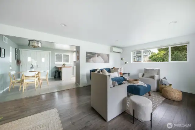 The living room seamlessly connects to the kitchen and dining areas, creating an effortless flow for everyday living and entertaining.