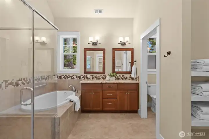 Full bathroom with soaking tub and separate shower