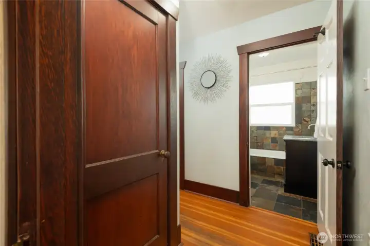 Hallway on main floor with door on the left to the unfinished basement.