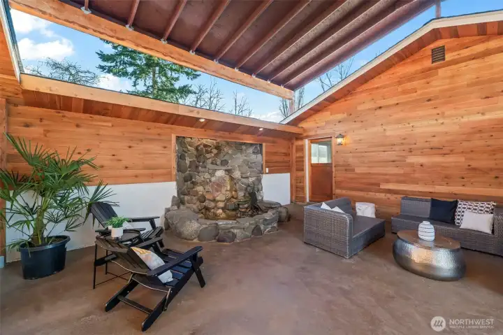 Gorgeous covered sitting area/breezeway walking from garage to side entrance with a tranquil fountain and beautiful stamped concrete