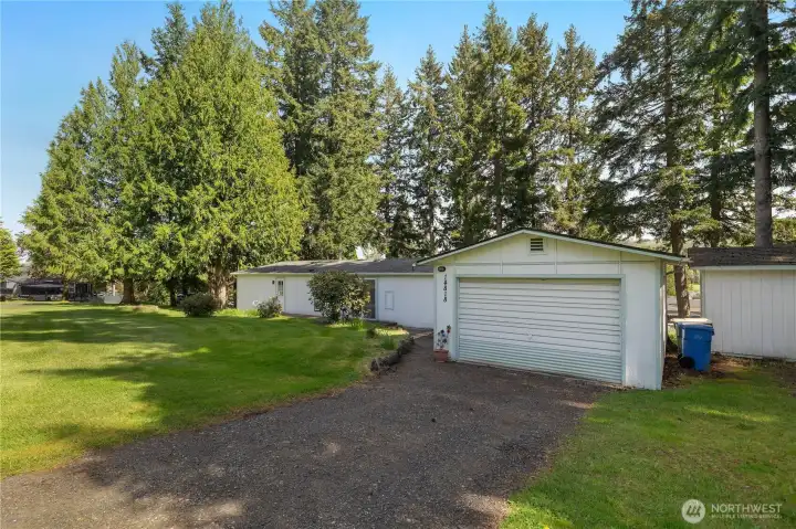 Arrive home to a quiet McIntosh Lake community setting with garage and generous yard space.