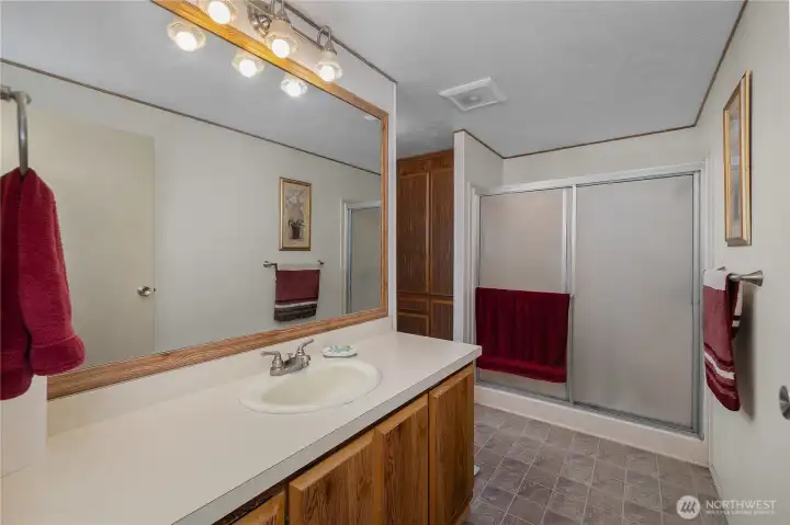Primary Bath - Start the day in a full bath with extended vanity, large mirror, and tub/shower combination.