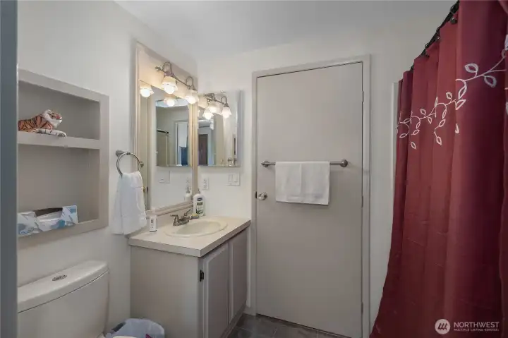 Hall Bath - Second bathroom includes a vanity, tub/shower area, and practical built-in storage.