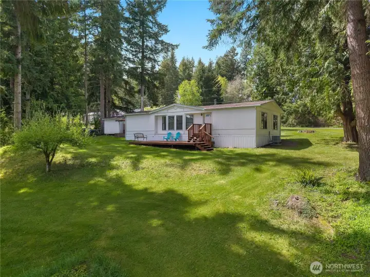 Relax on the deck and enjoy the peaceful yard, mature trees, and lake-community setting.