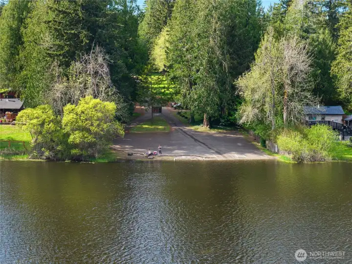 Water-facing view of the public access area framed by mature trees and natural shoreline.