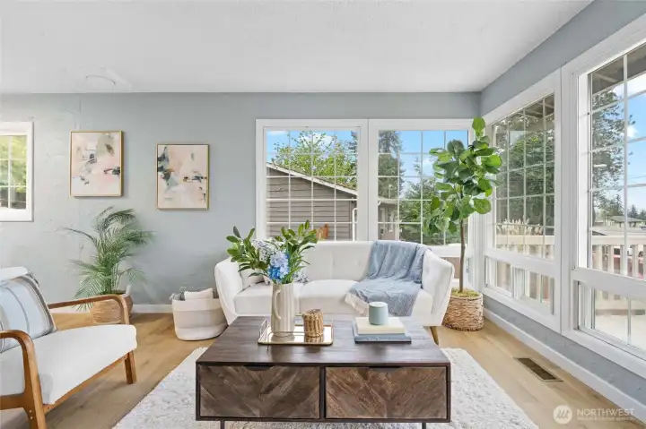 Huge Floor to ceiling windows in living room boast plenty of natural light