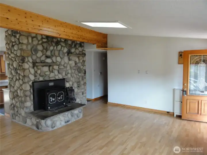 Cathedral ceilings to this massive fireplace in the living room.