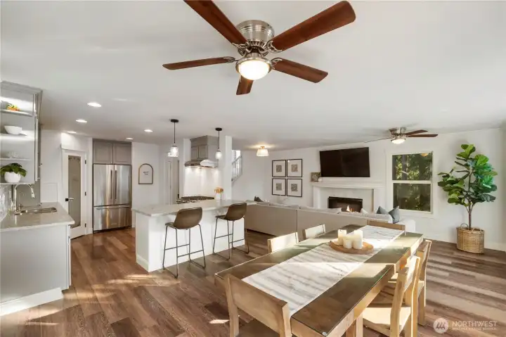 Updated kitchen showcases all-new appliances including a gas range and hood, sparkling quartz counters, and a walk-in pantry