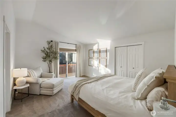 Upstairs primary suite is true retreat featuring 2 closets, slider to deck overlooking Lake Tapps and ensuite spa bath