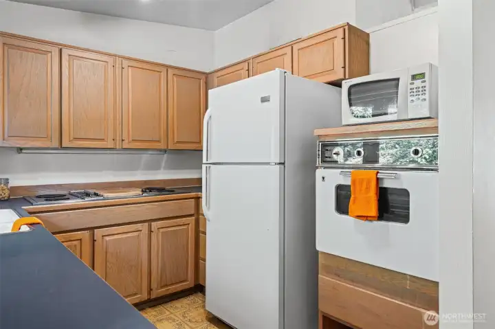 Full appliance package included— wall oven, cooktop, refrigerator, and dishwasher. Generous upper and lower cabinet storage throughout. This kitchen gives you a functional starting point in one of the Eastside's most affordable entry-level neighborhoods.