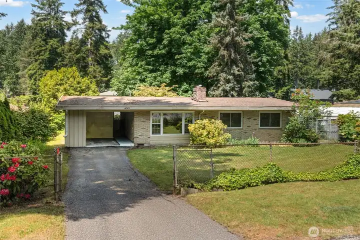 Your next chapter starts here. This Eastgate Bellevue brick rambler sits on a fully fenced lot surrounded by towering Pacific Northwest trees — the kind of established neighborhood where people buy and stay for decades.