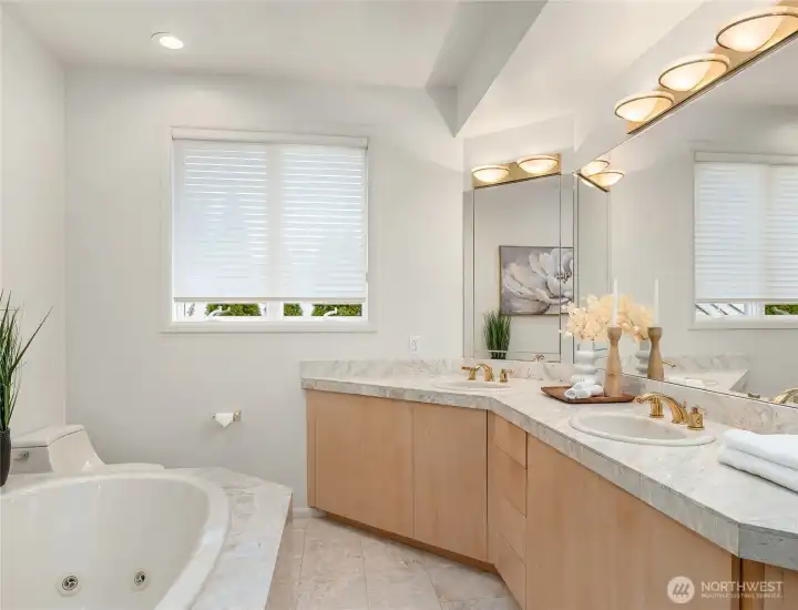 Primary bathroom with jetted tub, dual vanities, and large walk-in shower. Primary bathroom with jetted tub, dual vanities, and large walk-in shower.