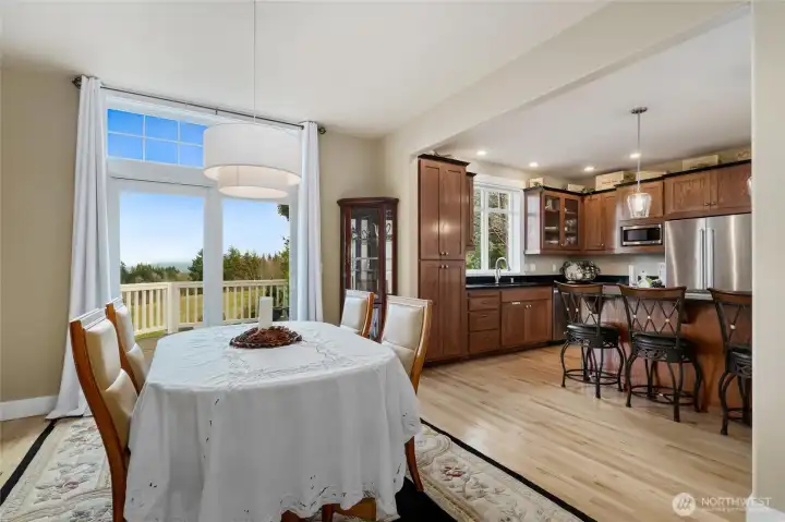 Dining area and kitchen w/eating space on main floor in main house. Beautiful hardwood floors.