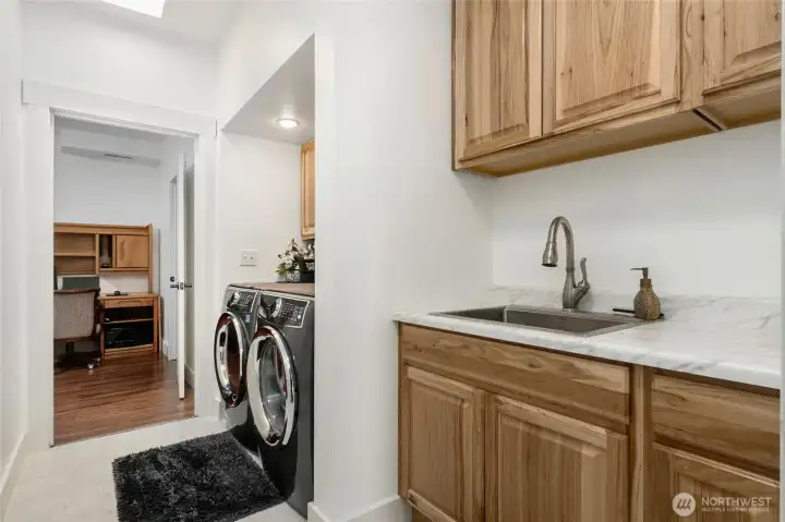 Laundry room w/utility sink & cabinets downstairs