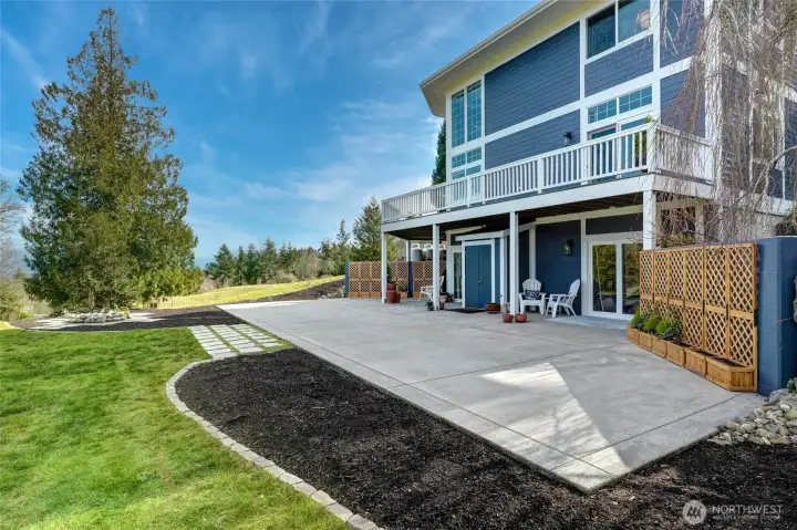 Rear yard with large patio lawn planting beds and beautiful views.