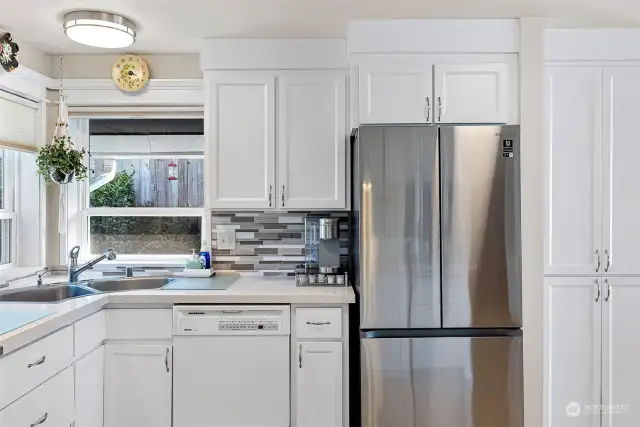 Chefs kitchen with Stainless appliances and is open to the kitchen nook