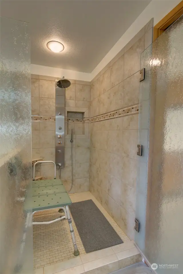 Spacious shower with custom tile work.