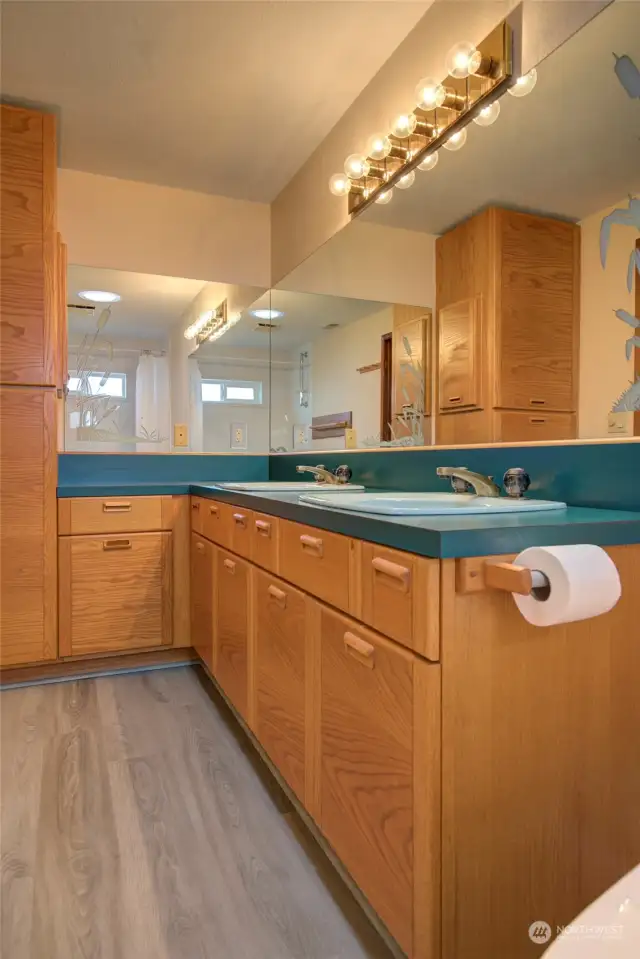 Upstairs bathroom has large dual vanity sinks.