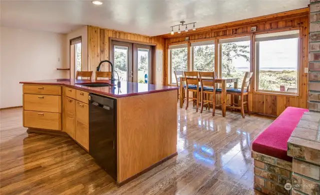 Dining area also overlooks the estuary, and rear door opens out to the deck.