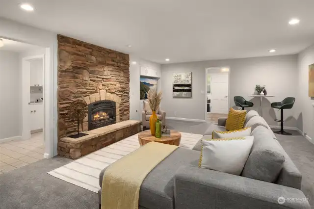 Built-in shelving and cupboards next to the fireplace. Plenty of room to curl up and watch a movie or host a festive game night. To the left of the fireplace is access to the mud room, powder room and laundry room.