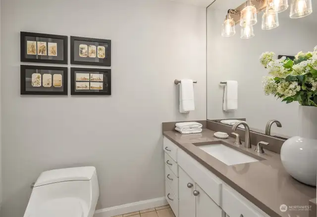 Recently remodeled main floor powder room with new counter, sink, fixtures, lighting and fresh paint.