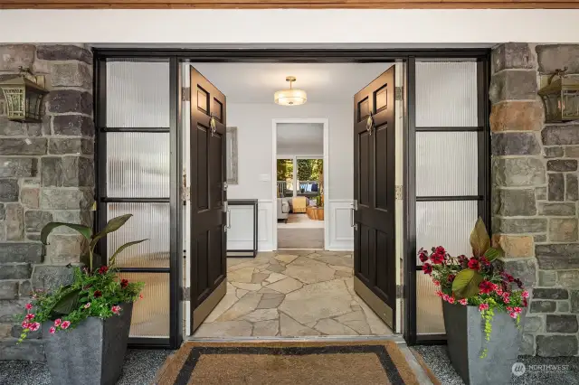 The covered porch welcomes you into the formal entry where you'll discover lovely period details and high-end modern finishes.