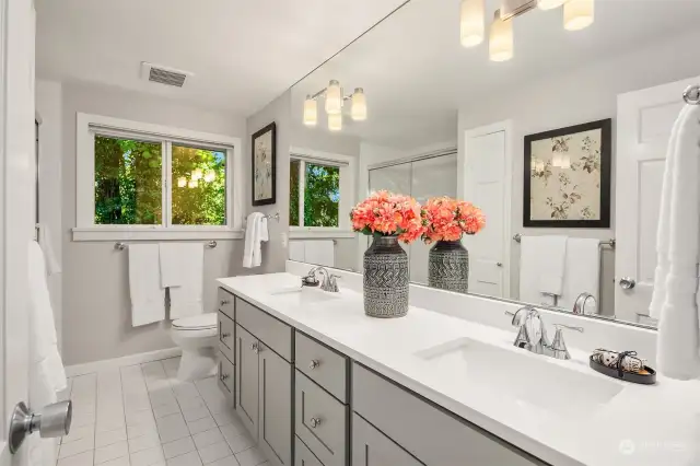 Full bathroom serving the upstairs bedrooms has been updated with new countertop, sinks, fixtures, lighting and fresh paint.