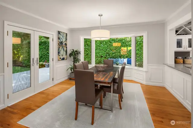 A bay window in the dining room let's in ample light and overlooks the wrap-around deck and greenbelt.