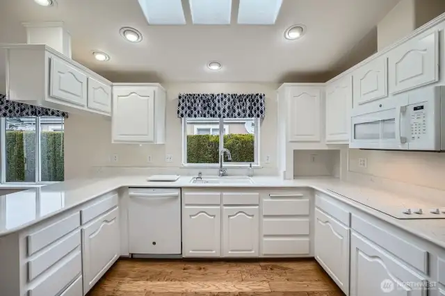 The recently refreshed kitchen offers quartz countertops, a brand new cooktop, and a skylight to keep it bright.
