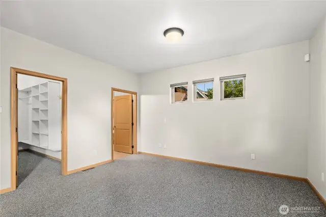 Primary bedroom with walk-in closet and private full bathroom