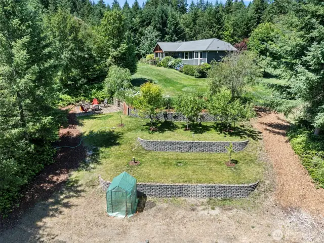 terraced with fruit trees at the top. Fire-pit is there to the left