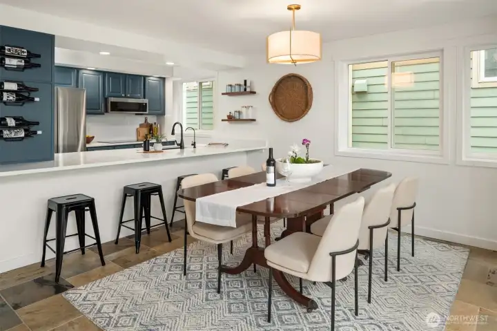 This condo lives large, featuring a dedicated dining area big enough for a 12+ person  table—perfect for holiday gatherings and dinner parties, a rare luxury in condo living