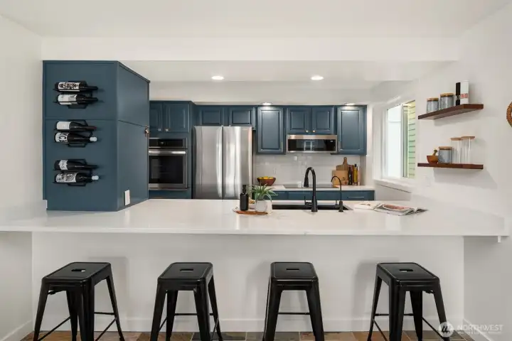The remodeled kitchen blends style and functionality with quartz countertops and  breakfast bar for added prep space, and all new stainless steel energy efficient  appliances—including an induction cooktop, convection oven, microwave, refrigerator,  dishwasher, disposal—were recently replaced.