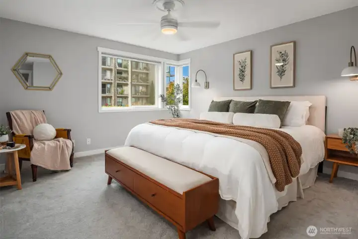 Retreat to a spacious primary suite that easily fits a king-sized bed plus additional  furniture.