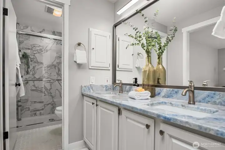 Bathrooms  throughout were fully refreshed with stone counters, new showers, updated fixtures, and  sleek finishes.