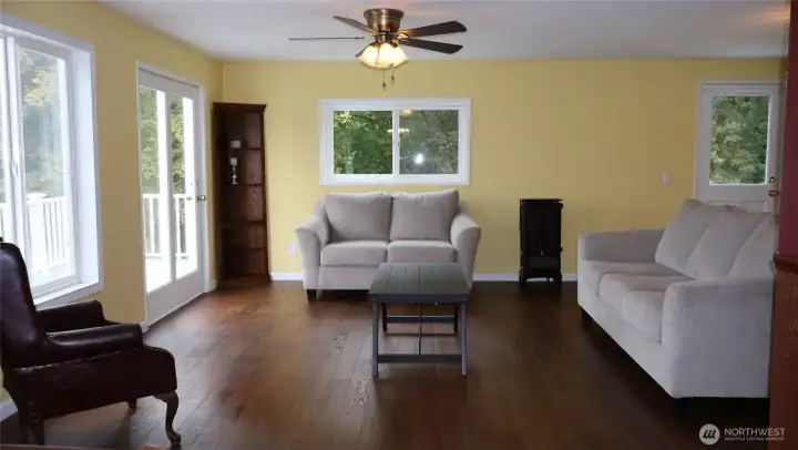 Natural light fills the living room with views of the sound
