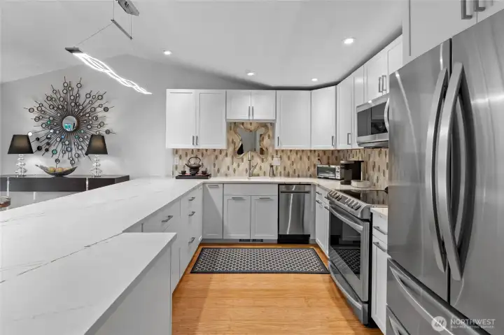 Tastefully designed kitchen with new cabinetry, quartz and SS appliances.