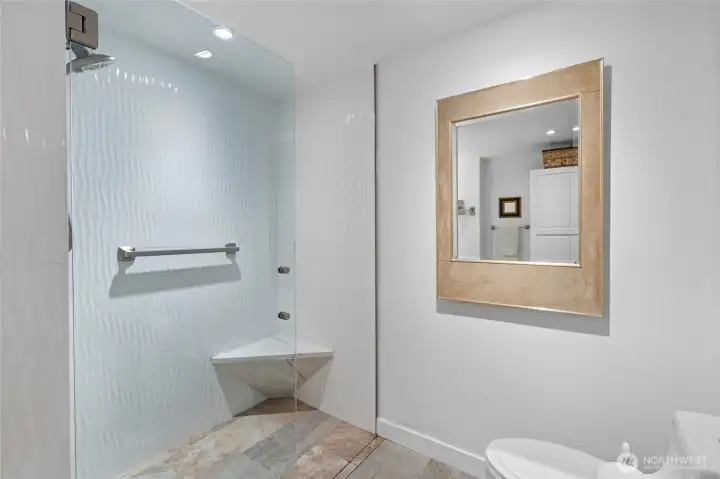 Walk-in shower with a seat.