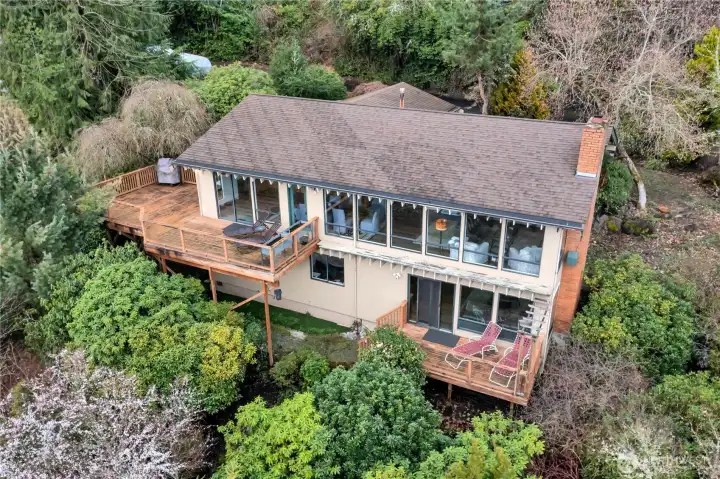 Better view of the exterior of the home. Living room and dining room across front of the home. Lower deck off family room.