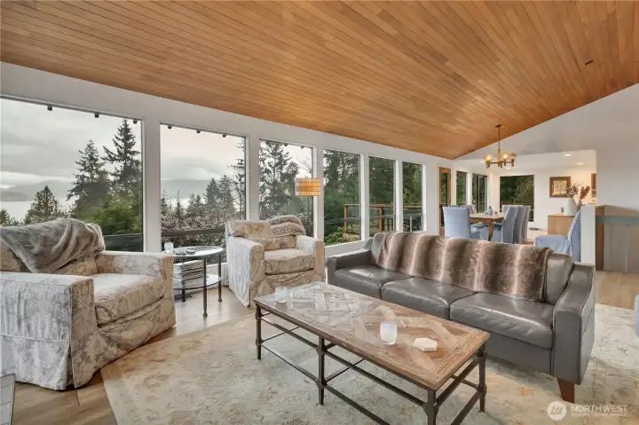 View from the living room looking into the dining area and deck with views to see forever.