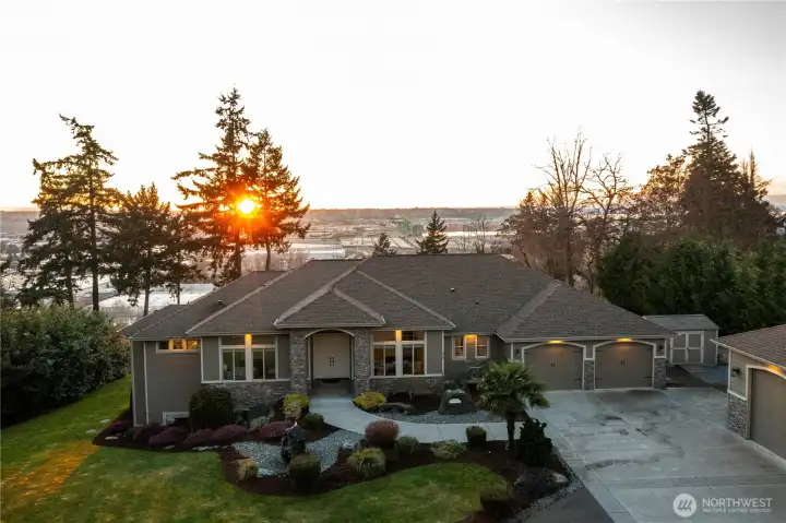 Stroll the walkway past the stunning water feature and enter through the double door entry into this 2016 custom built home.  This estate is equipped with efficient geothermal heating an cooling, heated floors, and forced air climate control across seven separate zones for maximum comfort.