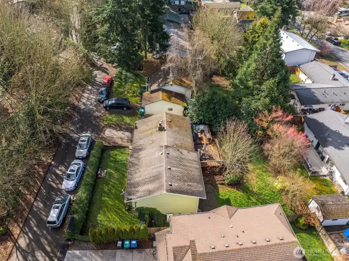 Overhead perspective highlighting lot layout, rooflines, and proximity to neighboring properties.