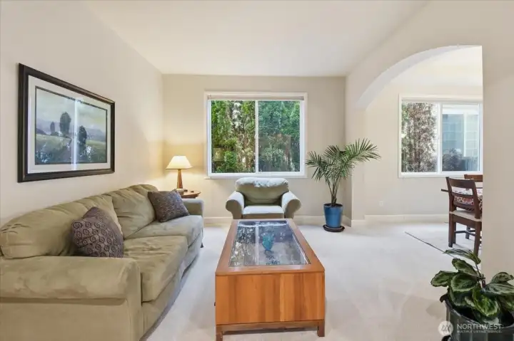 Dining and living rooms elegantly framed by graceful archways, adding architectural charm and a sense of refined flow.