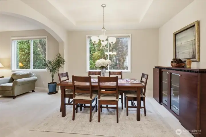 Dining and living rooms elegantly framed by graceful archways, adding architectural charm and a sense of refined flow.