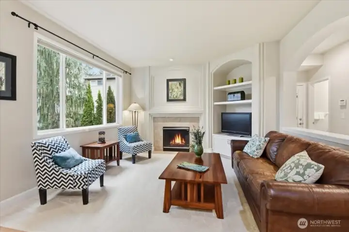 An open and spacious family room anchored by a cozy gas fireplace, creating the perfect setting for comfortable everyday living and effortless entertaining.