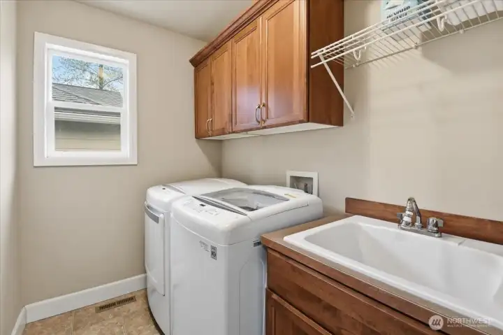 Upstairs laundry room provides convenient, everyday functionality located near the bedrooms for ease of use.