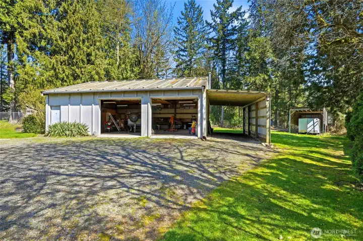 Featuring a massive 1,080 sq ft detached shop with heated workspace, extra refrigerator, 10x30 enclosed tool shed, 12x28 carport, and 15x29 covered RV parking